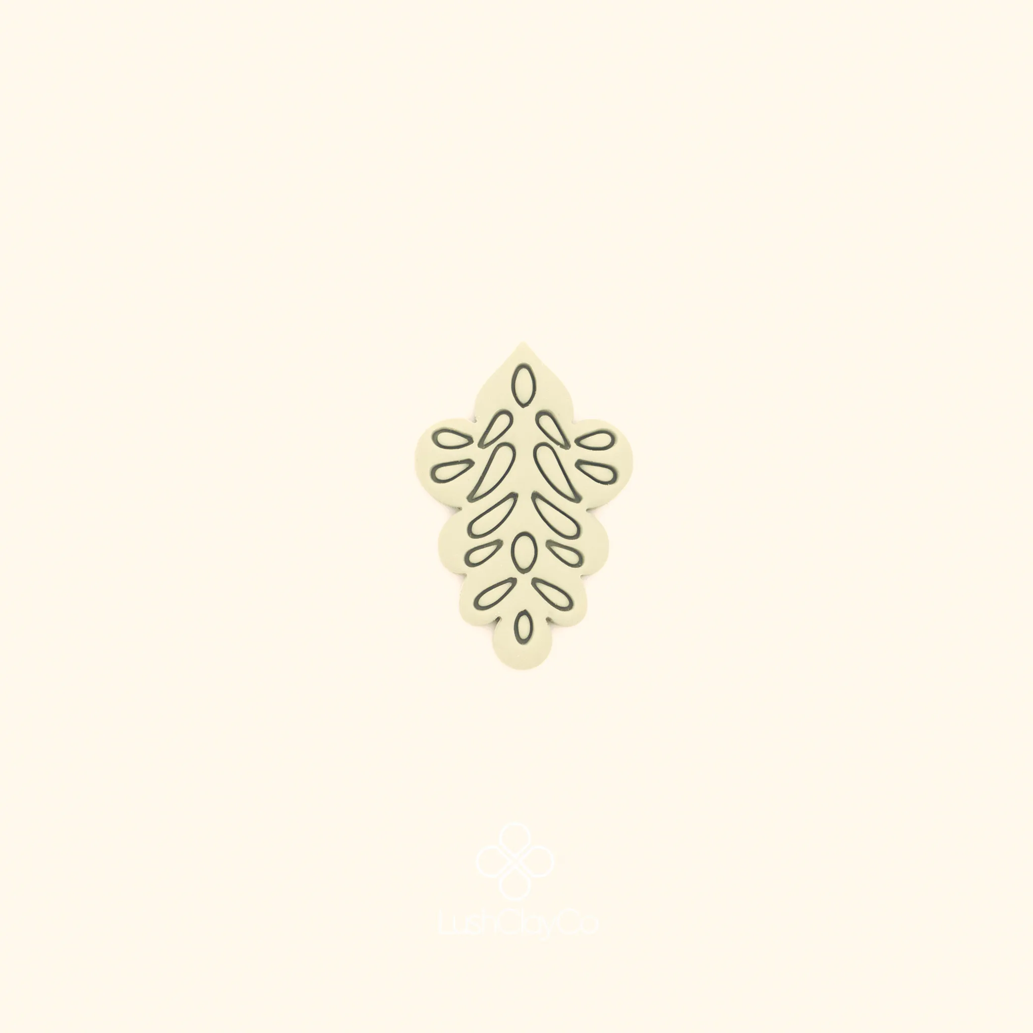 Clay impression of the Gül Motif ottoman rose cutter showing open branching teardrop and oval forms pressed into polymer clay within a diamond silhouette