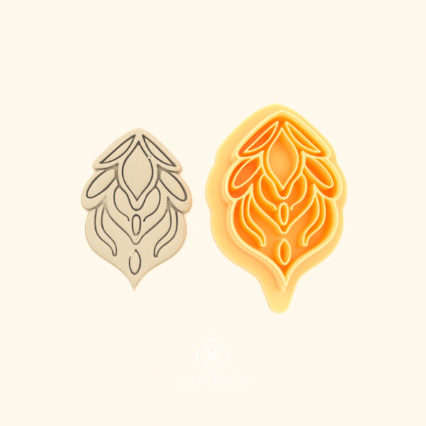 Alev Penç hatayi polymer clay cutter alongside clay impression showing teardrop silhouette with flame tendrils and nested oval interior