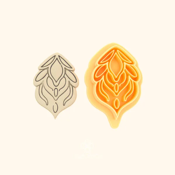 Alev Penç hatayi polymer clay cutter alongside clay impression showing teardrop silhouette with flame tendrils and nested oval interior