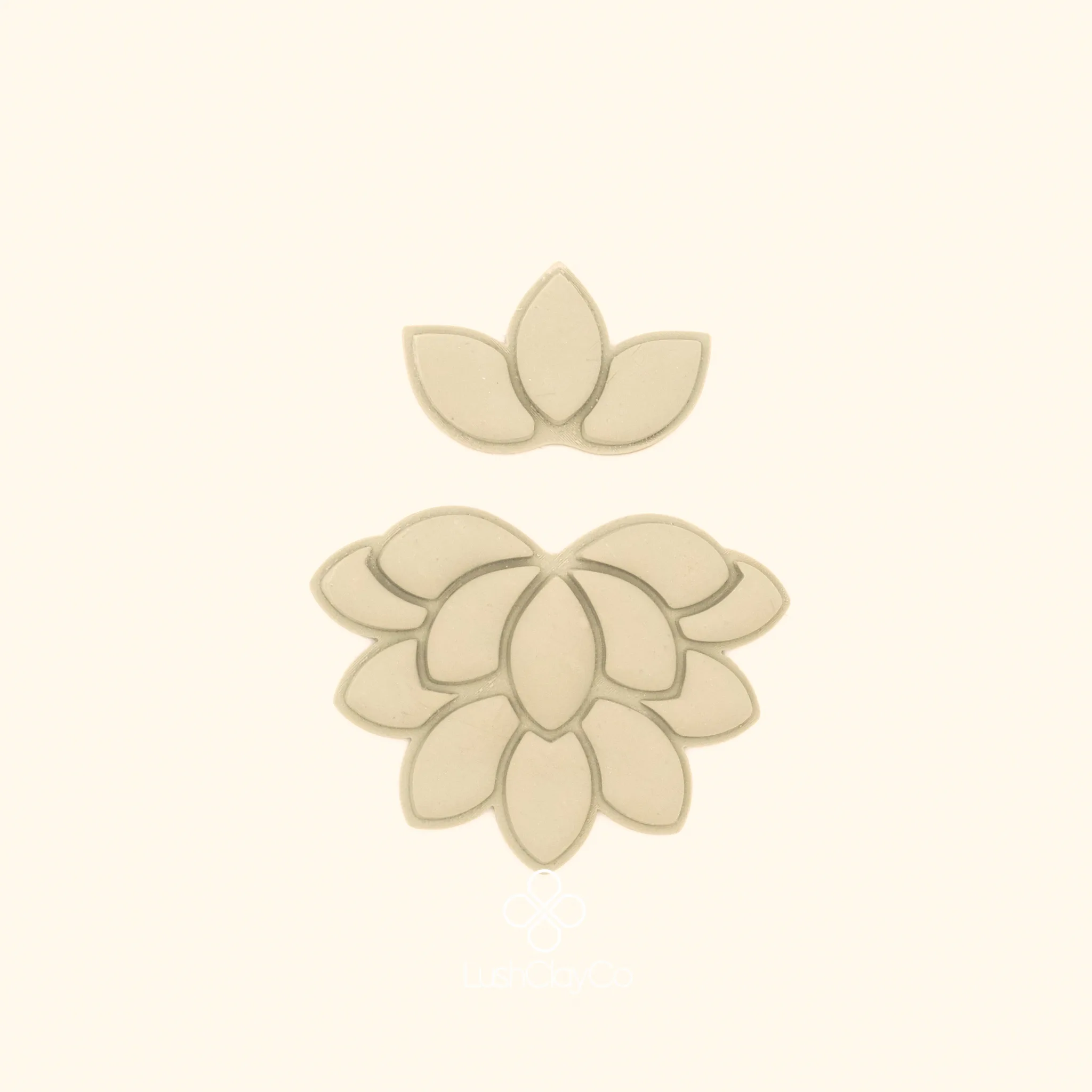Clay impressions of the Nilüfer Deste botanical cutter set showing tiered lotus bloom and three petal crown form pressed into polymer clay