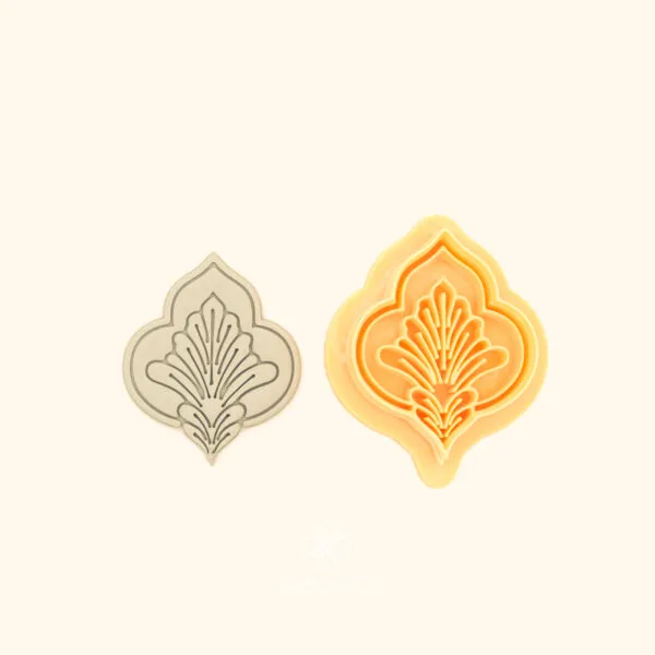 Karanfil Scroll ottoman polymer clay cutter alongside clay impression showing pointed ogival silhouette with carnation motif and fine radiating lines from central stem