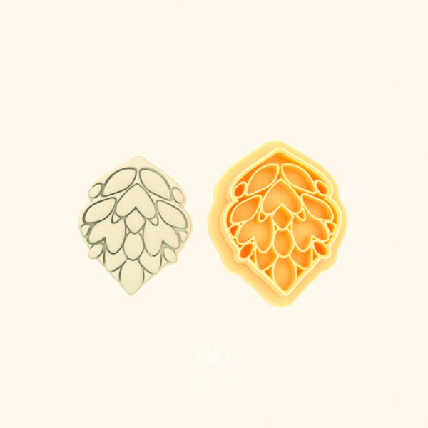 Penç Flora penç hatayi polymer clay cutter alongside clay impression showing teardrop shield form with densely layered rows of rounded petal cells