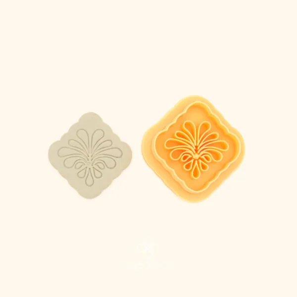 Zümrüt Fan rumi polymer clay cutter alongside clay impression showing rounded square form with symmetrical curved teardrop spray from a central stem