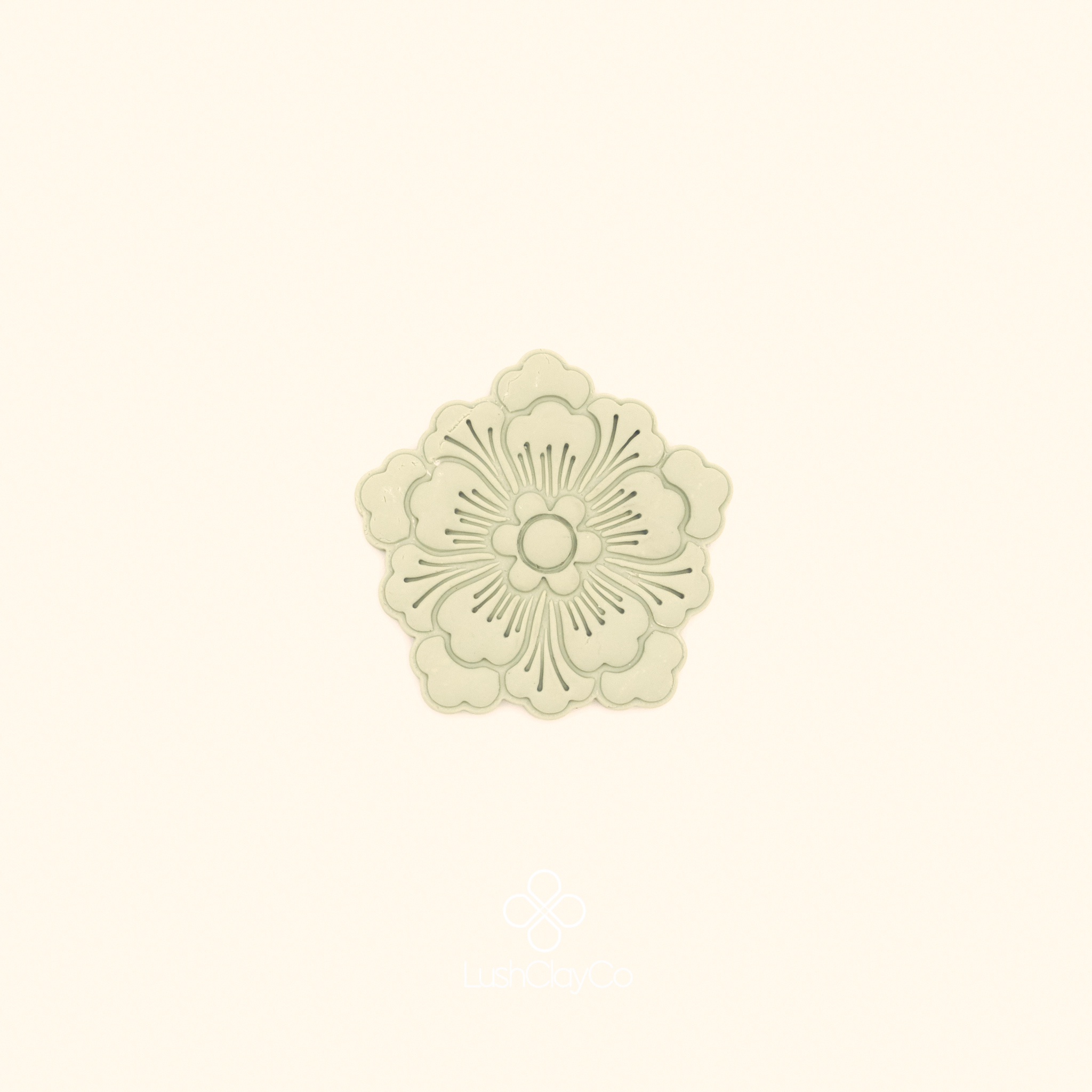 Clay impression of the Şahane Deste botanical cutter showing full rosette composition with fine radiating lines pressed into polymer clay