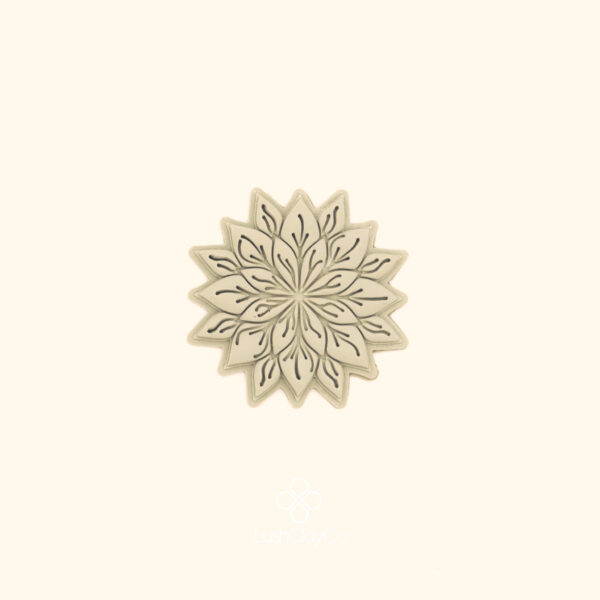 Clay impression of the Sultan Flora hatayi cutter showing two rings of detailed pointed petals and fine interior linework pressed into polymer clay