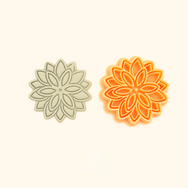 Güneşim botanical polymer clay cutter alongside clay impression showing two rings of elongated pointed oval petals radiating from a small central circle