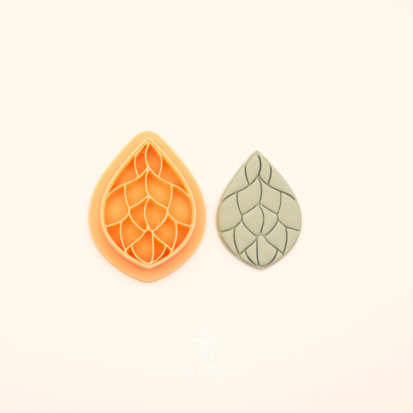 Damar Damla rumi polymer clay cutter alongside clay impression showing teardrop silhouette with bold curving vein channels dividing the interior into open sections