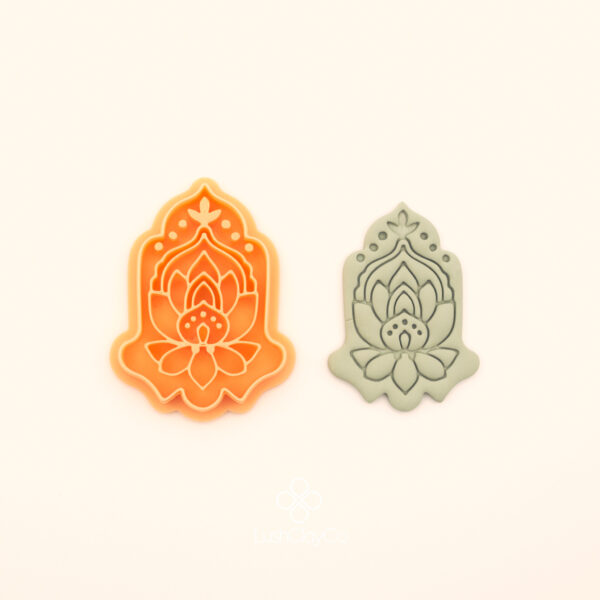 Bereket botanical polymer clay cutter alongside clay impression showing hand shaped silhouette with lotus bloom base, layered petal forms and dotted crown detail