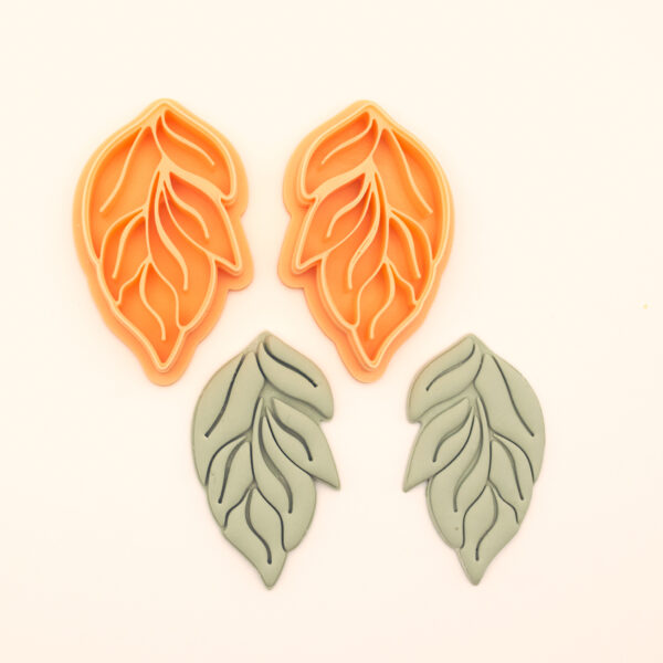 Çift Yaprak botanical polymer clay cutter set alongside clay impressions showing large and small leaf forms with bold and fine vein channel interior detail