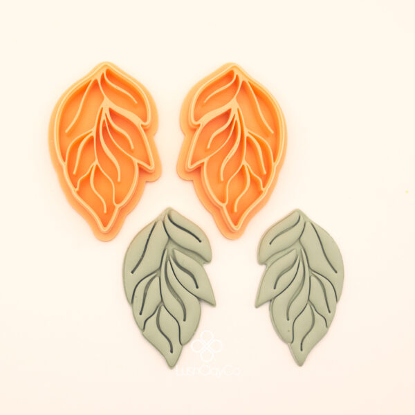 Çift Yaprak botanical polymer clay cutter set alongside clay impressions showing large and small leaf forms with bold and fine vein channel interior detail