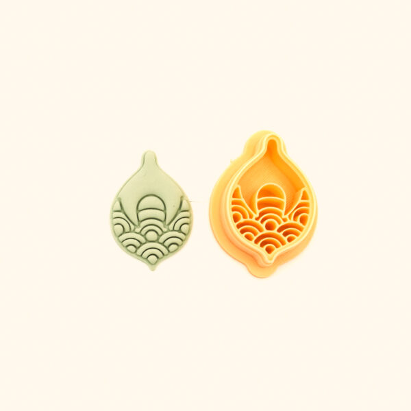 Deniz Şafağı polymer clay cutter and its clay impression, a wave-and-sunrise teardrop