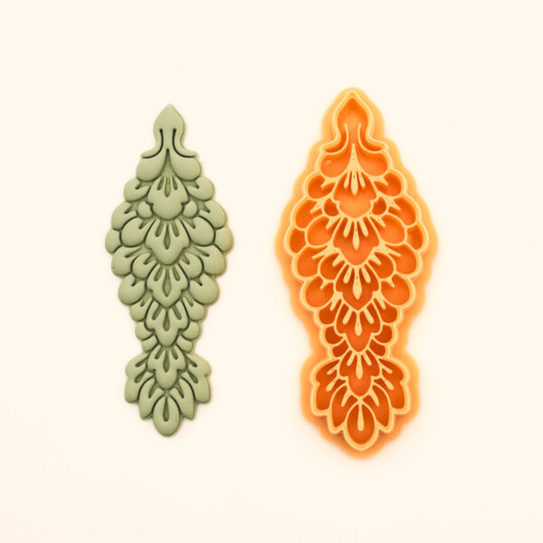 Elif Kamet polymer clay cutter and its clay impression, a tall cypress-form scale column
