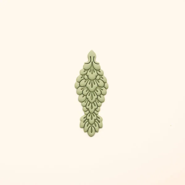 Clay impression from the Elif Kamet polymer clay cutter showing layered scale detai