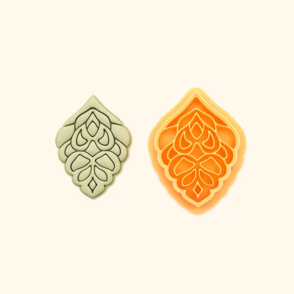 Haşmet hatayi polymer clay cutter alongside clay impression showing pointed ogival silhouette with dense symmetrical layered teardrop and petal cluster interior