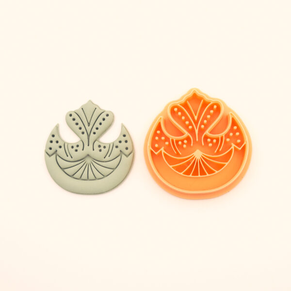 Tuba ottoman polymer clay cutter alongside clay impression showing dome arch silhouette with fan palmet base, wing forms and dotted berry clusters