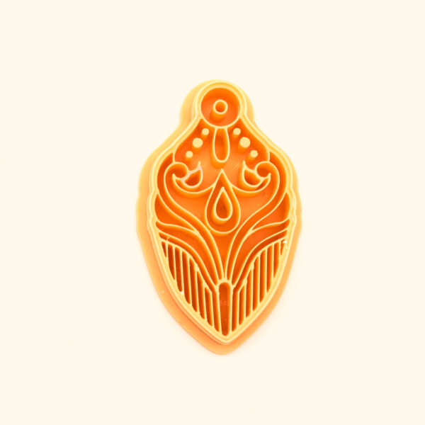 Şebnem Rumi Clay Cutter Şebnem cutter, a winged rumi-scroll pendant with a central teardrop