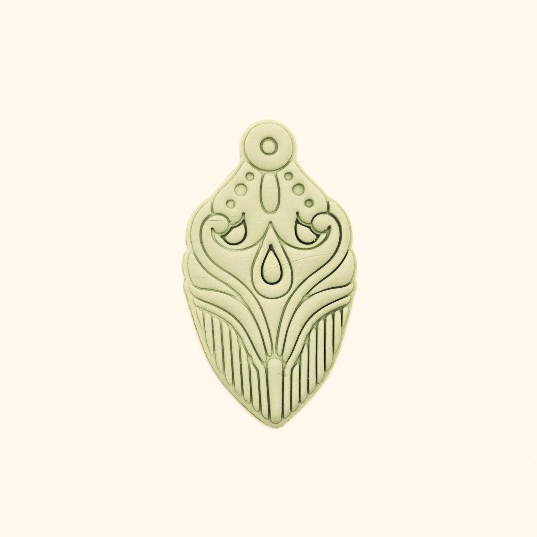 Clay impression from the Şebnem polymer clay cutter showing rumi scrolls and drop detail