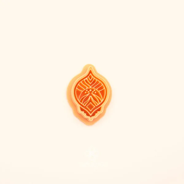Zerrin hatayi polymer clay cutter showing pointed oval outer form with dense symmetrical interior of curved leaf forms, vein lines and dot clusters