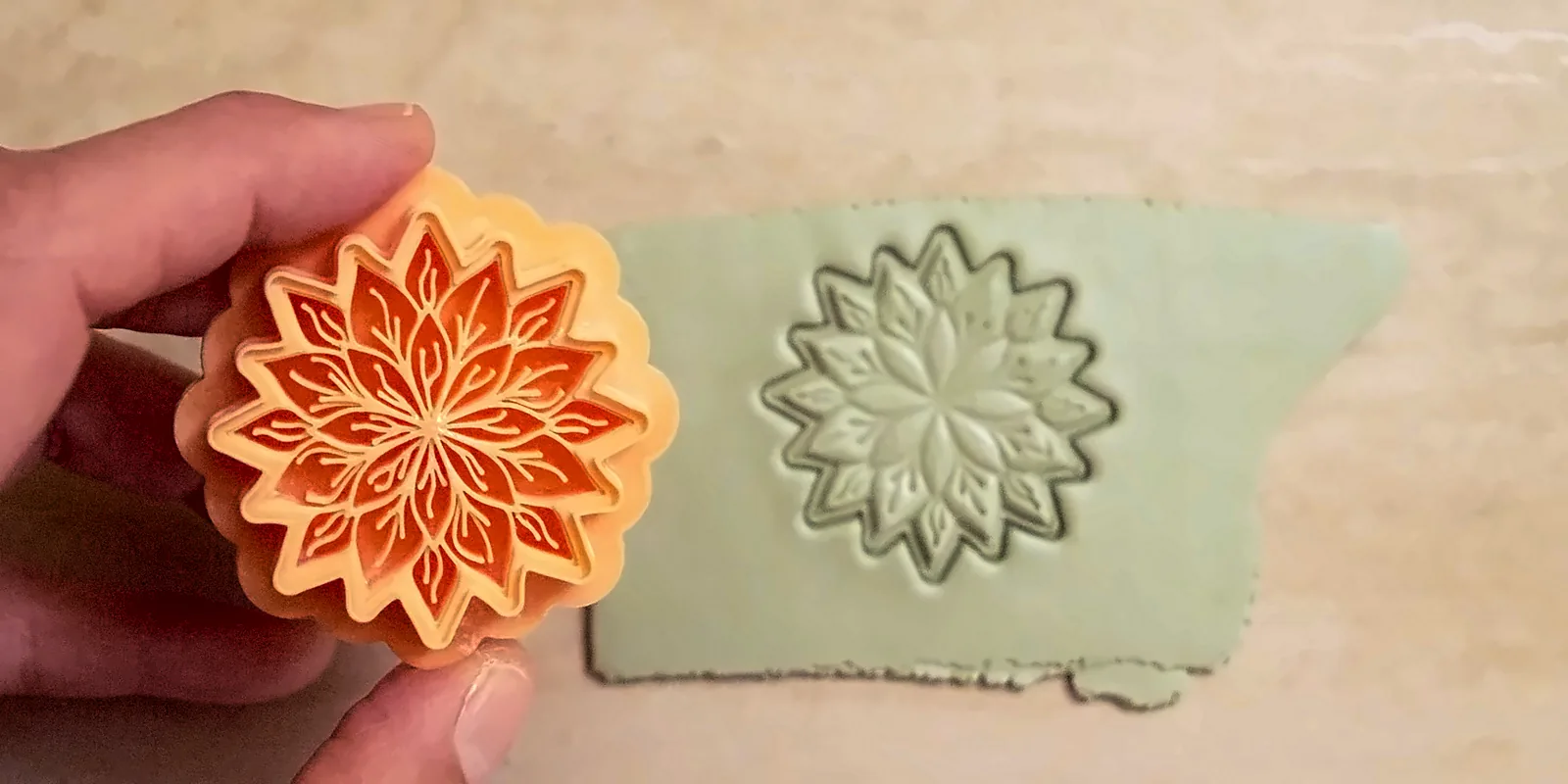 Floral polymer clay cutter beside its impression in clay